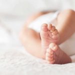 Historic Cradle In The West Wing? baby feet on a soft white blanket