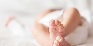 baby feet on a soft white blanket