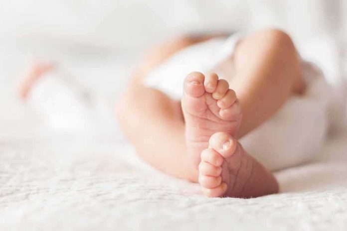 shutterstock_1111986902 baby feet on a soft white blanket