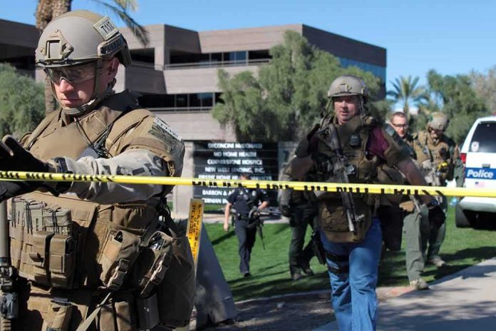 Tactical police officers behind yellow caution tape at an outdoor scene