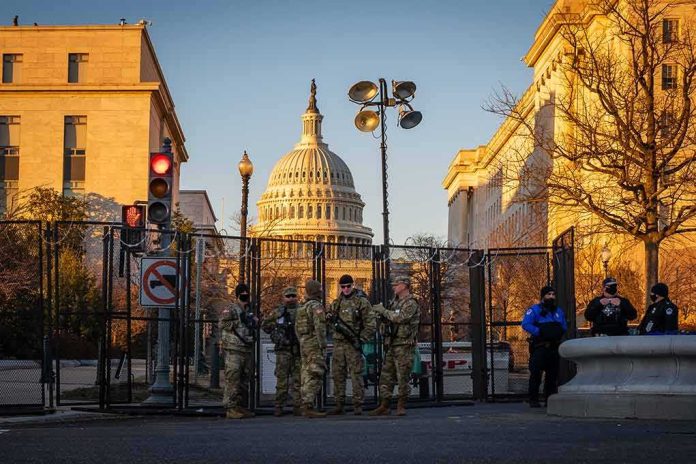 shutterstock_1898227372 National Guard troops stand at a security fence near the U.S. Capitol