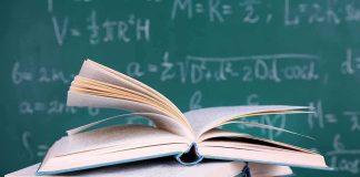 Seven-Figure Royalties Inside The Supreme Court A stack of books with one open on top, in front of a chalkboard filled with mathematical equations