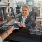 airport check-in agent handing back a passport