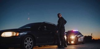 Golf Course Alibi? Romo Clip Explodes Police officer stands beside a stopped car at dusk