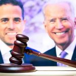 Judge’s gavel with two blurred people in the background