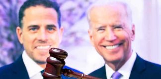 Judge’s gavel with two blurred people in the background