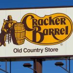Cracker Barrel roadside sign with logo against blue sky