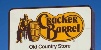 Cracker Barrel roadside sign with logo against blue sky