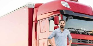 Veterans Fast-Tracked, Unlicensed Drivers Dumped man standing in front of a red semi truck