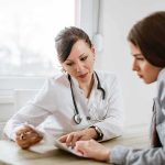 Doctor consulting a patient at a desk