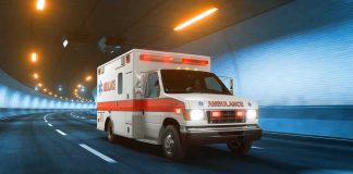 Ambulance driving through a tunnel with emergency lights on