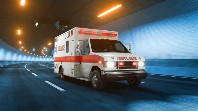 Ambulance driving through a tunnel with emergency lights on