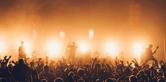 Metal Band Slams Netflix Juggernaut Rock band performing on stage with bright backlights and cheering crowd