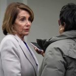 Pelosi’s Pivot Sparks Biden Meltdown Mystery woman in light coat being interviewed outdoors