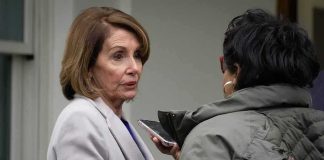 Pelosi’s Pivot Sparks Biden Meltdown Mystery woman in light coat being interviewed outdoors