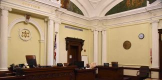 Courtroom Shock: Stalking Plea Upends Murder Trial empty courtroom with judge's bench and columns