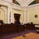 Backroom Talks Jolt Luigi Mangione Saga empty courtroom with judge's bench and columns