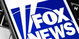 Fox Anchor’s COVID Booster Scare Fox News logo displayed on a smartphone screen