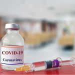 vaccine vial and syringe on a counter in a clinic