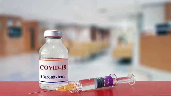 vaccine vial and syringe on a counter in a clinic