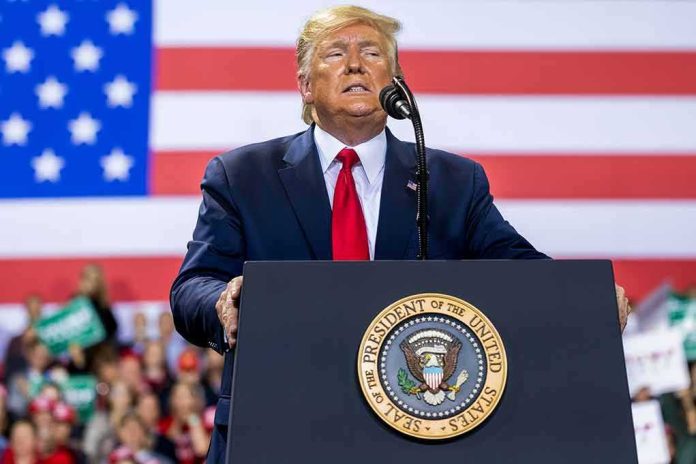 person speaking at a podium with U.S. flag backdrop