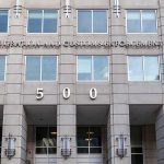 US government building facade with flags and number 500