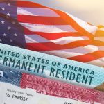 Trump-Era Crackdown Nukes 175,000 Visas U.S. flag with visa and permanent resident cards
