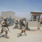 308 Freed—Biggest Rescue Yet Soldiers in desert uniforms run past a checkpoint amid dust