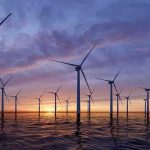 Trump Pays Billions To Kill Offshore Wind Offshore wind turbines at sunset over calm sea