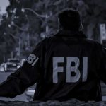 Cartel Drum Kill: FBI Insider Speaks FBI agent in jacket facing a city street at dusk