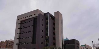 Modern concrete and dark glass government building on a cloudy day
