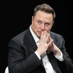 Elon Musk Turbocharges GOP Ground Game man in a suit with hands clasped thoughtfully