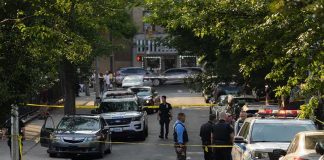 Frat Coke Ring Exposed at Penn State Police officers secure a residential street with patrol cars and yellow tape