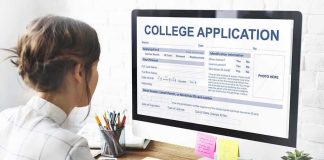 Student completing a college application on a desktop computer