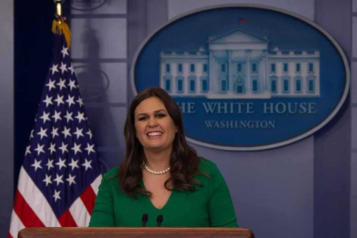 shutterstock_744405145 woman speaking at a press podium in the White House briefing room