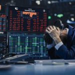 Kelce Named Victim In Wild Ponzi Scheme Trader stressed out by multiple declining stock charts.