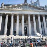 DOJ Heat Engulfs Gavin Newsom Reporters and photographers gathered outside a neoclassical courthouse