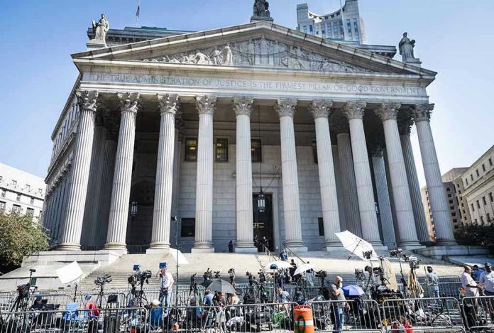 2445868619 Reporters and photographers gathered outside a neoclassical courthouse