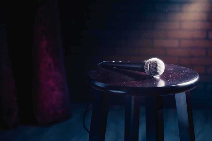 shutterstock_1007889328-1 Microphone on a wooden stool under stage lighting