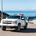 Military Base Breach Panic: Drugs, Chaos, Questions Border patrol SUV parked near beach fence
