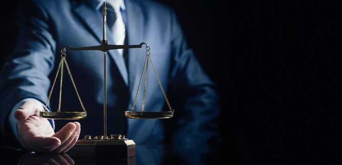 Scales of justice held by a person in a suit