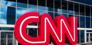 Press Pass Purge – Court Showdown Looms CNN red logo sculpture outside a modern glass building
