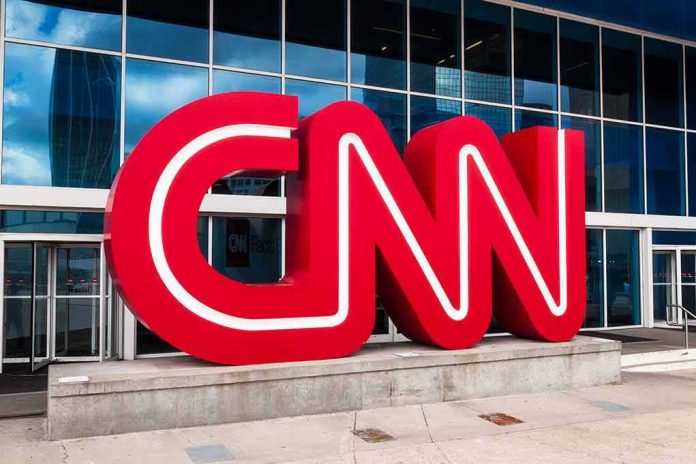 shutterstock_1032509656-1 CNN red logo sculpture outside a modern glass building