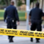Domestic Call Erupts—Officer Killed, Chaos Follows Police officers walking past caution tape at a crime scene