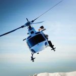 Helicopters Targeted, Town Locks Down helicopter banking over snowy mountains