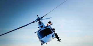 Helicopters Targeted, Town Locks Down helicopter banking over snowy mountains