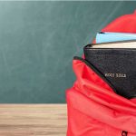 California’s Prison Tablets Used for Child Exploitation Red backpack with books on a classroom desk