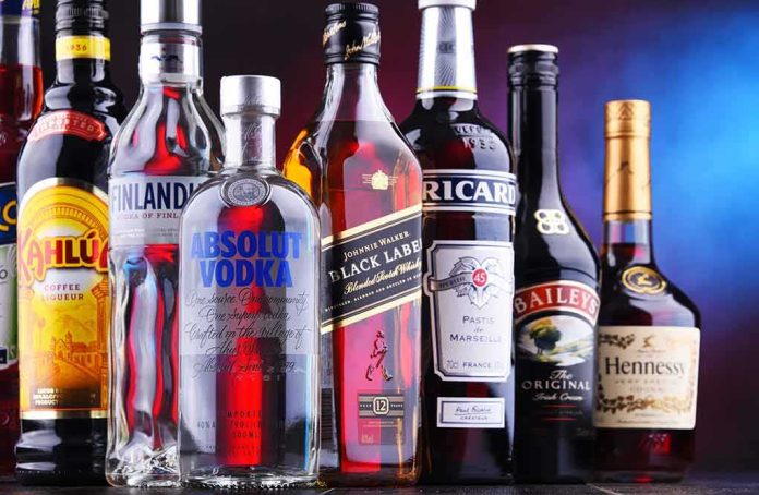shutterstock_1232938570 Assorted liquor bottles arranged in a row