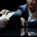 Seventy Percent Inflation — System Buckling Hands exchanging cash across a table