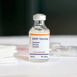 Rubella Roots Spark Shapiro–RFK Firestorm MMR vaccine vial on a white surface